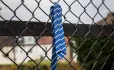 School leavers tie on fence